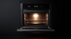 Open oven preheating with a tray inside, illuminated with a warm light