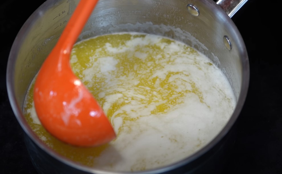 Ghee in a stainless steel pot, being heated gently