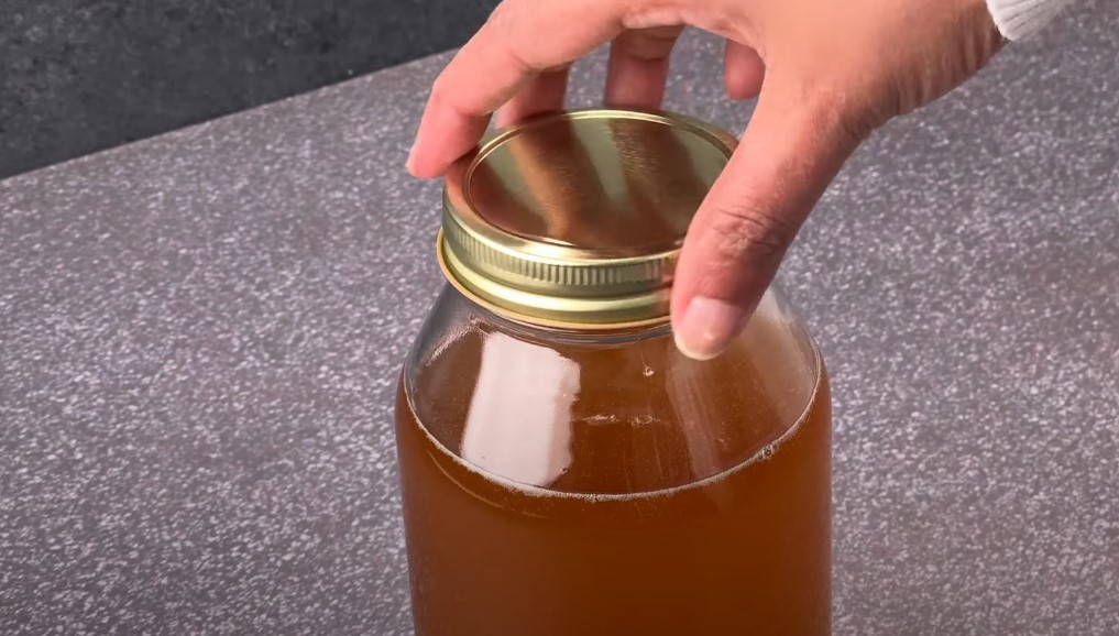 Securing the lid on a glass jar, ensuring a tight seal