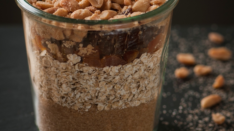 Baking mix jar filled with oats, dried fruits, brown sugar, and peanuts, ready to use or gift