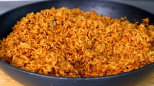 Cooked seasoned rice resting in a black skillet after being removed from heat