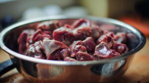 Raw gizzards in a metal bowl, ready for cooking to make gravy