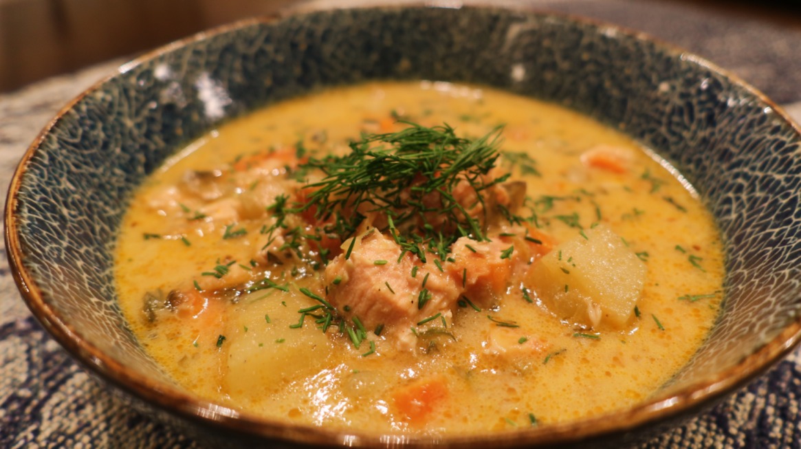 Bowl of creamy salmon chowder with salmon chunks, diced potatoes, carrots, and fresh dill garnish