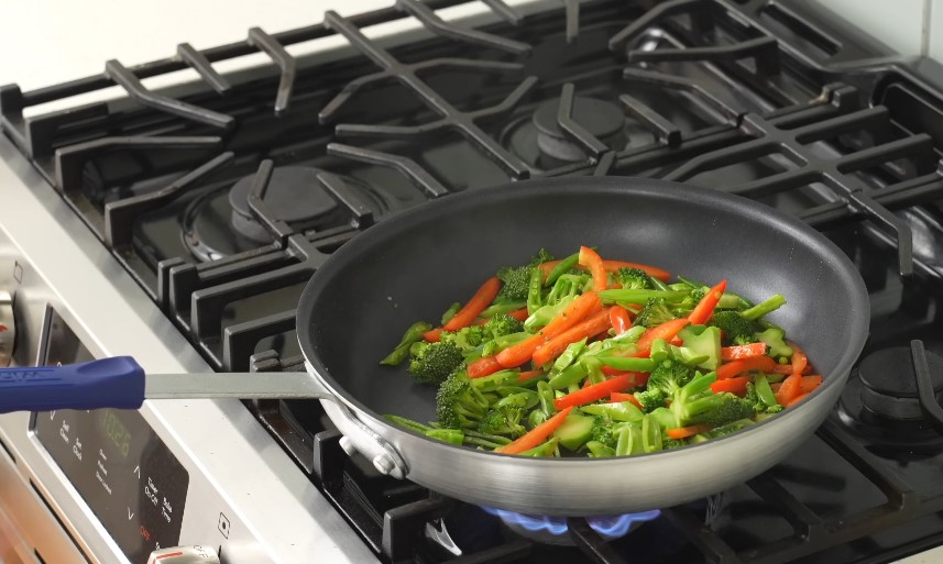 Vibrant vegetables sizzle in a hot pan, ready for a delicious meal